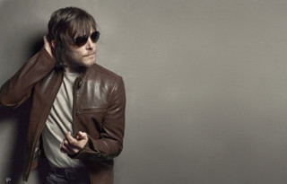 Man brownjacket sunglasses leaning wall - visual art free wallpaper