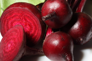 Red vegetables closeup table leaves - a white surface free wallpaper