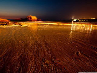 Beach night people lighthouse distance - a few person free wallpaper
