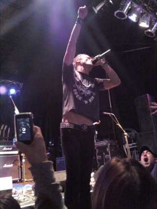 Man holding microphone stage audience - precisionism free wallpaper