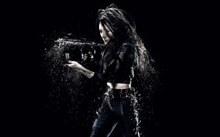 Woman holding gun water splash - a woman holding free wallpaper for desktop