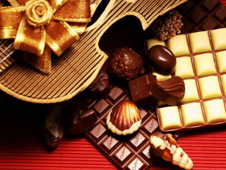 Chocolates candybars redtablecloth bow stilllife - a red tablecloth free wallpaper