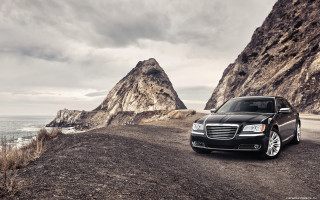 Black car mountain range water 2 - a rocky cliff free wallpaper