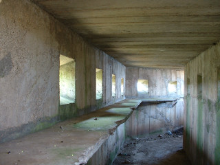 Long concrete hallway bench hole - a bench in the middle of it free wallpaper