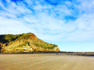 Sandy beach mountain blue sky - a sandy beach free wallpaper for desktop