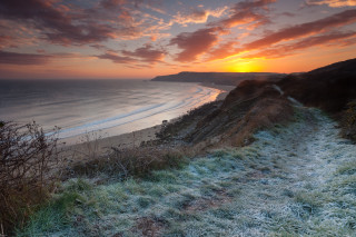 Beach path sunset water foreground - a sunset in the background and a body of water free wallpaper
