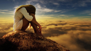 Woman sitting rock clouds head - somber free wallpaper for desktop