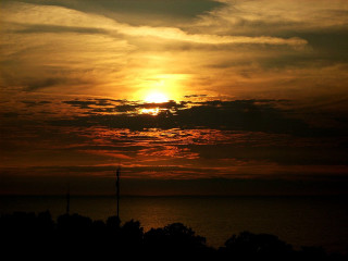 Sunset clouds trees water background - the foreground and a body of water free wallpaper for desktop