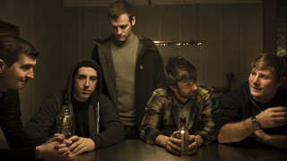 Men sitting table beer bottles 2 - a group of men sitting free wallpaper