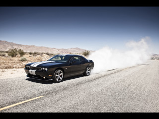 Black car driving dusty road - tire free wallpaper
