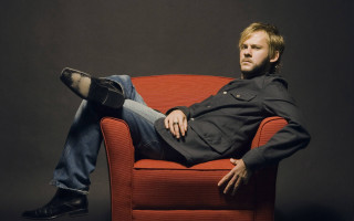 Man sitting red chair legs - his foot free wallpaper