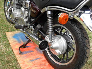 Motorcycle parked grass red light - a black tire free wallpaper