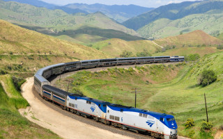 Train mountainside city traveling tracks - a train free wallpaper