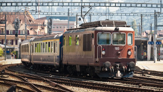 Train city buildings mountain tracks - the background and a mountain in the distance free wallpaper