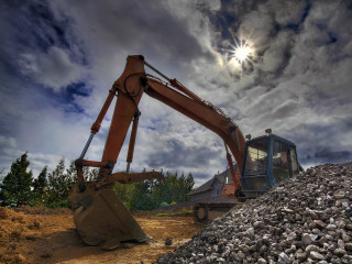 Large machine digging rocks cloudy - cloudy free wallpaper