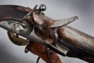 Gun metal handle leather sheath - a close up of a gun free wallpaper