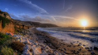 Beach cliff water sunset plane - a cliff and a body of water free wallpaper