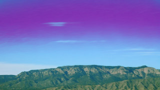 Mountain purple sky plane distant - a blue sky and some clouds free wallpaper