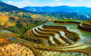 Hillside river mountains rice terraces - a mountain range in the background free wallpaper