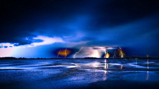 Lightning strikes water boat dark - a boat in the distance free wallpaper