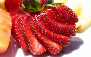 Strawberry banana closeup white surface - arcimboldo free wallpaper