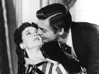 Man kissing woman cheek black - a curtain behind her free wallpaper