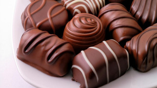 Plate of chocolates with white - white stripe free wallpaper