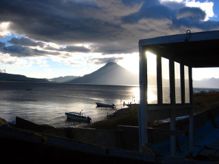 Boat water cloudy sky mountains - the water under a cloudy sky free wallpaper