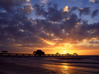 Sunset beach pier people walking - a sunset over a beach free wallpaper