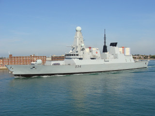 Military ship sailing city skyline - daphne allen free wallpaper