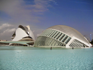 Large building water sky clouds - a large body of water in front free wallpaper