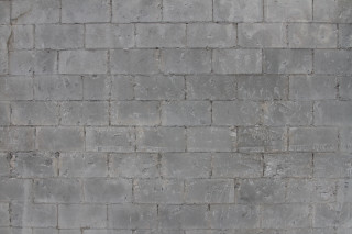 Person walking street brick wall - texture free wallpaper