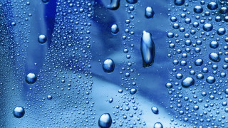 Water droplets blue surface background 3 - a close up of water droplets free wallpaper