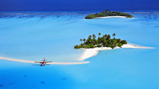 Island person ocean plane flying - a small island in the middle of the ocean free wallpaper