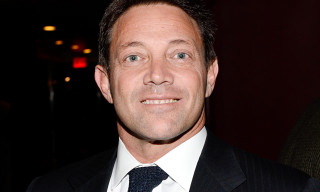 Man suit tie smiling dark - a red light in the background free wallpaper