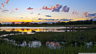 Sunset lake bridge clouds grassy - a grassy area in the foreground free wallpaper