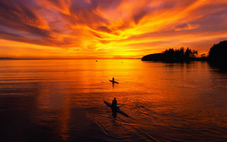 Person riding surfboard water sunset - a sky free wallpaper for desktop