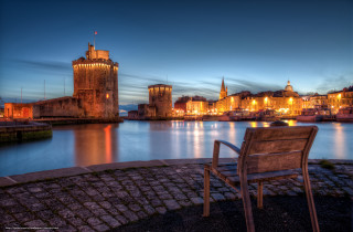 Bench brick walkway water night - a castle in the background free wallpaper for desktop