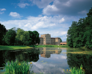 Large building lush green field - a lush green field next free wallpaper