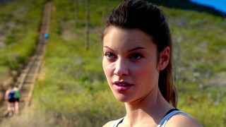 Woman field cellphone man background - her hand and a man in the background free wallpaper