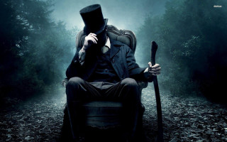 Man top hat coat sitting - dark shadow free wallpaper