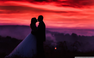 Bride groom kissing sunset sky - a bride and groom free wallpaper