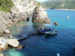 Boat docked rocky shore people - cagnaccio di san pietro free wallpaper