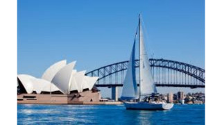 Sailboat sailing bridge building background - a large building in the background free wallpaper for desktop