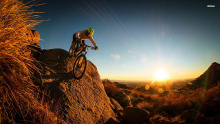 Man riding bike rocky hillside - a rocky hillside free wallpaper for desktop