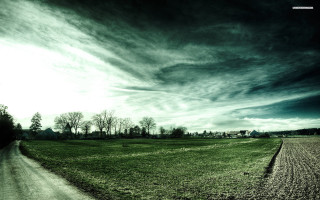Dirt road green field cloudy 3 - dark atmosphere free wallpaper