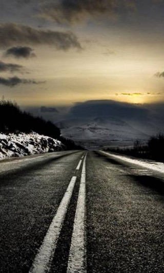Snowy road mountain cloudy sky - a road free wallpaper for mobile