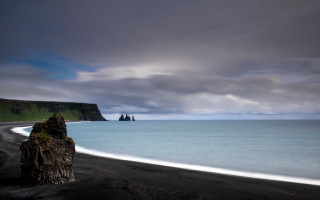 Black sand beach water cliff - derold page free wallpaper