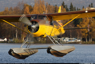 Yellow red plane flying water - the background and a boat free wallpaper