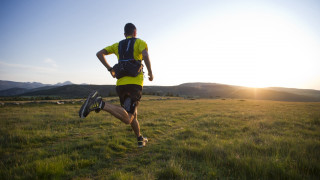 Man running field backpack helmet - the sun shining behind free wallpaper